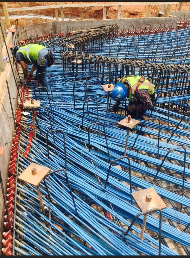 Crew placing post-tension tendons and anchors