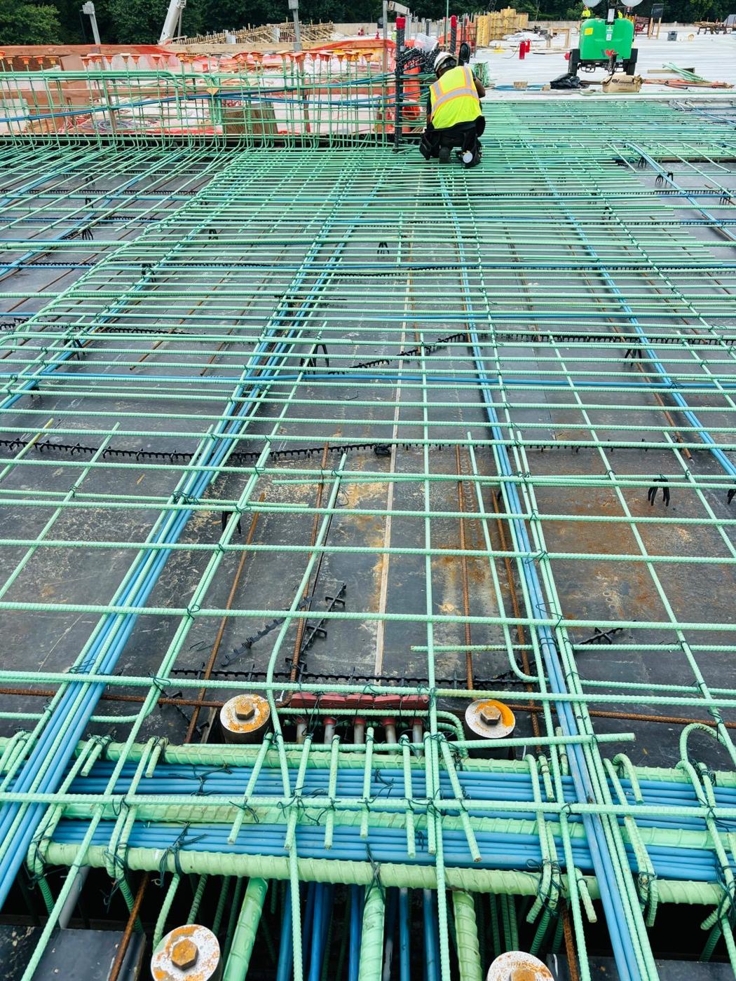 Banded tendons beneath green epoxy rebar