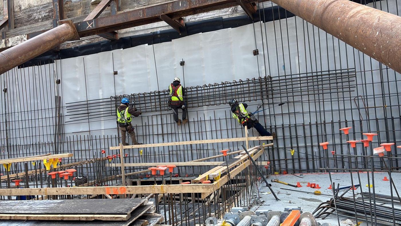 Rebar crew tying a wall cage below grade
