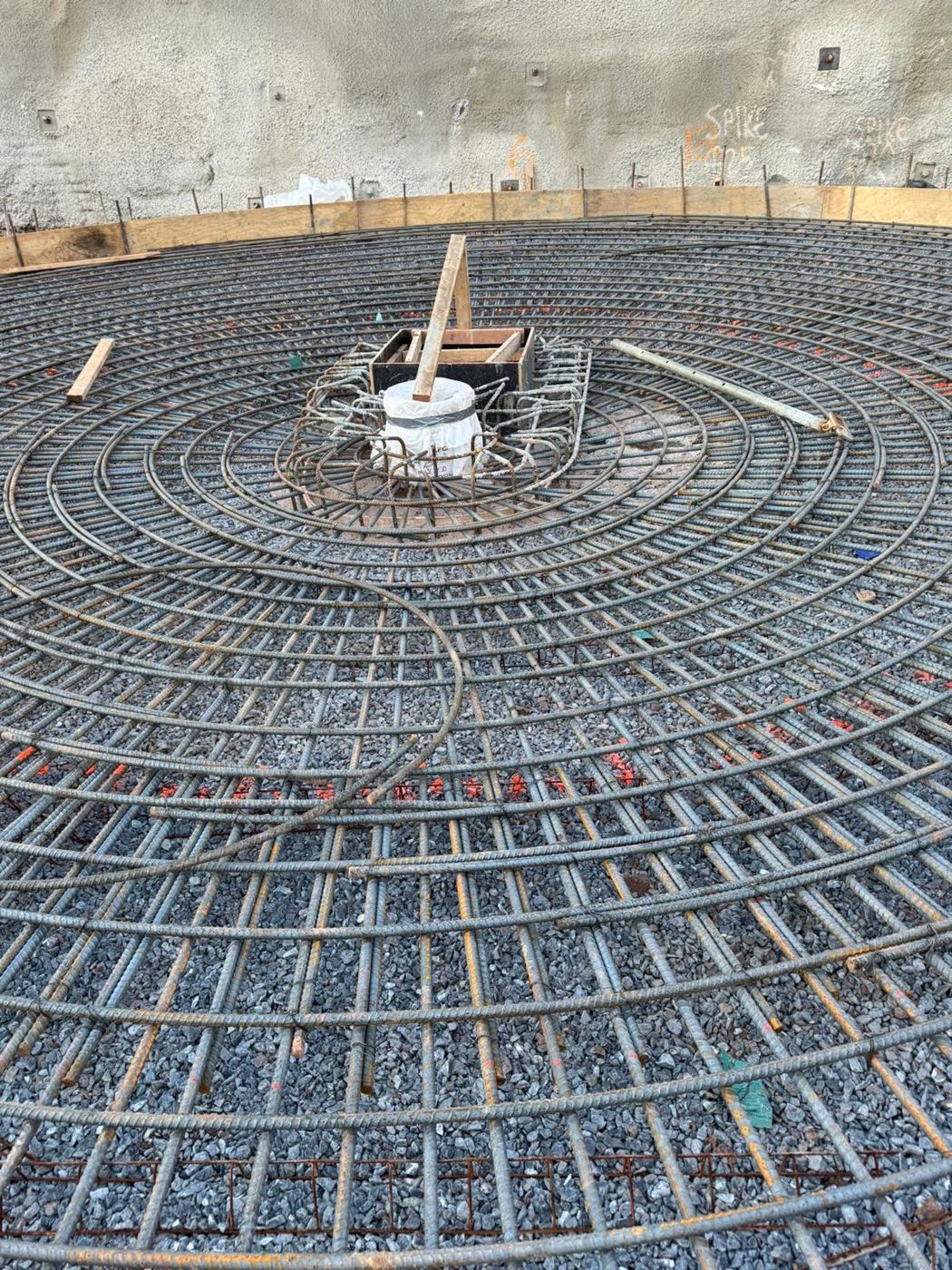 Close view of circular rebar rings around a center form